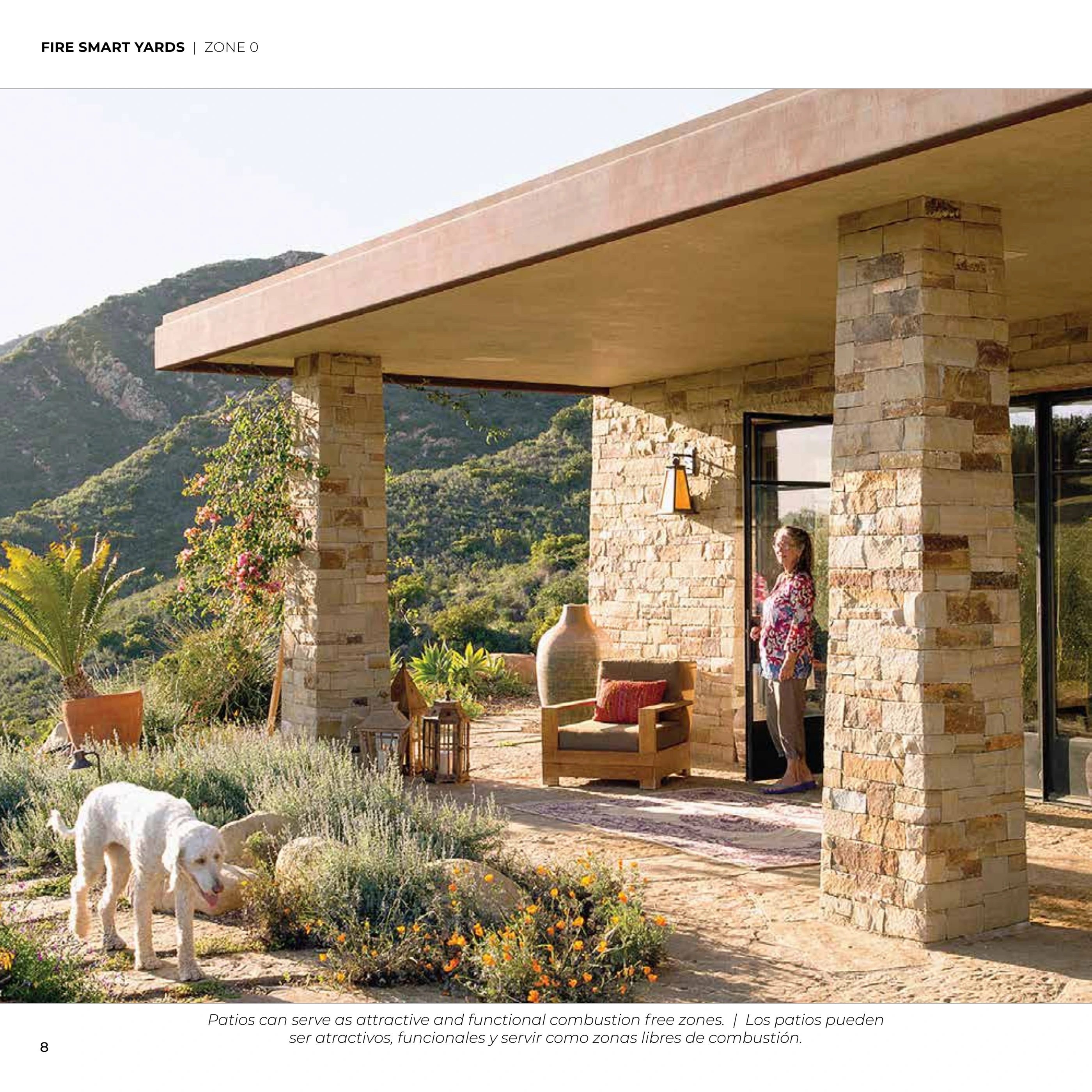 Fire-smart home with a stone patio and carefully maintained planting